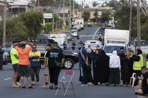 People gather at the scene of a shooting in Carlingford Street, Sefton, on Thursday morning.