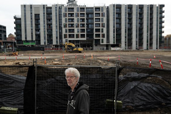 Long-time Kensington resident Simon Harvey stands near some of the Macaulay Road build-to-rent projects.
