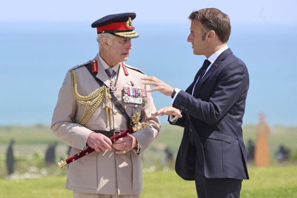 King Charles, left, and French President Emmanuel Macron talk following the UK commemorative event at the British Normandy Memorial to mark the 80th anniversary of D-Day, in Ver-sur-Mer, France.