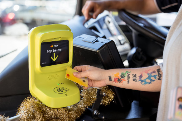 Rheannon McGillivray uses a bank card to pay her fare as part of trial of Victoria’s new myki-free payment system on Wangaratta’s bus network