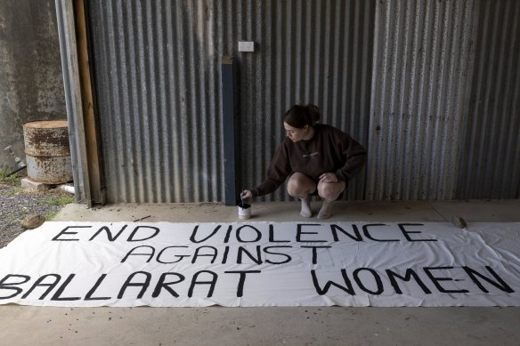Sissy Austin works on banners for the rally she organised in Ballarat in Friday night, to demand women have the right to be safe.