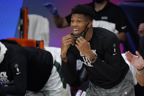 Injured league MVP Giannis Antetokounmpo did what he could from off the court for Milwaukee.