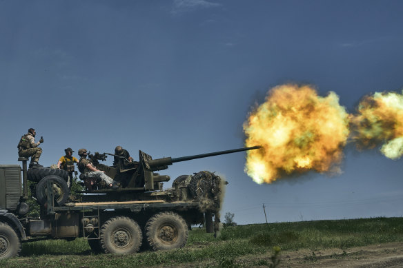 Ukrainian soldiers fire a cannon near Bakhmut.