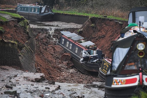 Boats lie damaged after a canal embankment collapsed in Whitchurch, Shropshire.