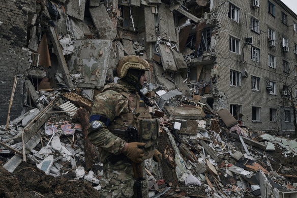 A Ukrainian soldier inspects a damaged apartment building in war-hit Avdiivka in the Donetsk region on April 12, 2023.