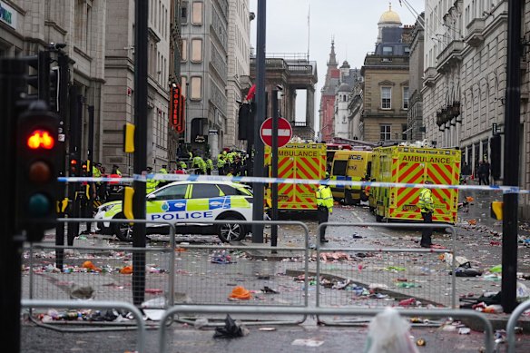 Police and emergency personnel at the parade site on Water Street, Liverpool, after the crash.