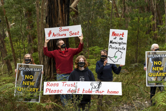 Residents protest against the proposed quarry at Arthurs Seat: Michelle de la Coeur (second from right), her husband Mark Fancett (second from left), and their daughter Alex Fancett, along with Janet and John Stanley (far left and far right). 