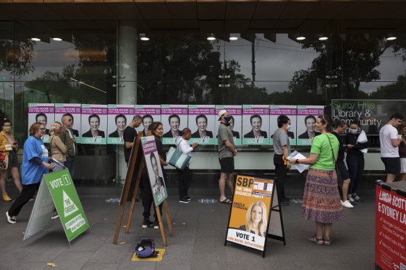 Residents queue to vote in person at Surry Hills Library on Saturday.