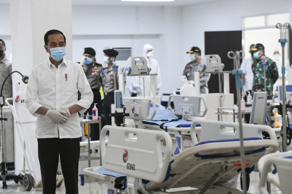 Indonesian President Joko Widodo, left, inspects a new emergency hospital set up amid the new coronavirus outbreak in Jakarta.