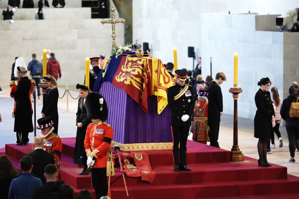 Queen Elizabeth II ’s grandchildren (counter-clockwise from left) Zara Tindall, Lady Louise Windsor, Princess Beatrice, Prince Harry, Duke of Sussex, Princess Eugenie, Viscount Severn, Peter Phillips and the Prince of Wales hold a vigil inside Westminster Hall.