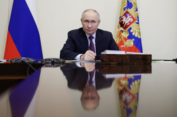 Russian President Vladimir Putin holds a video conference at his state residence outside Moscow on Thursday.