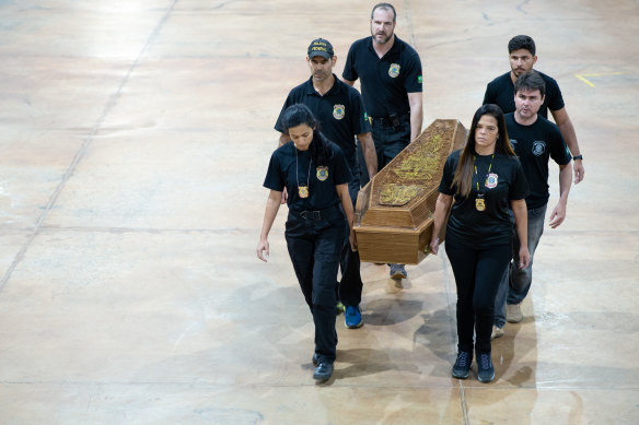 Members of the Brazilian police transport the casket carrying the recovered human remains.