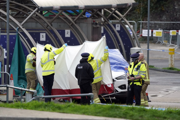 Emergency services investigate a car allegedly involved in the bomb attack on the migrant processing centre in Dover, last week.