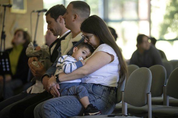 Bessie Napoli holds son Luciano at his pre-baptism at the Pines Church in Donvale.