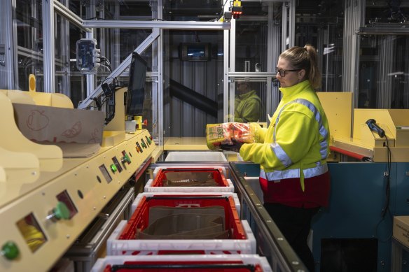 Retail team member Krystal Price at a picking station in the Coles customer fulfilment centre. 
