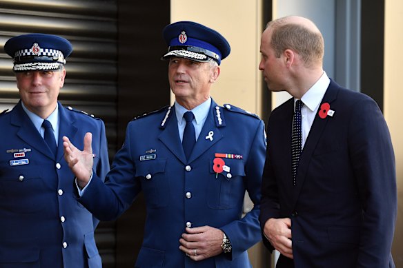 Mike Bush (centre) with Prince William in 2019. 