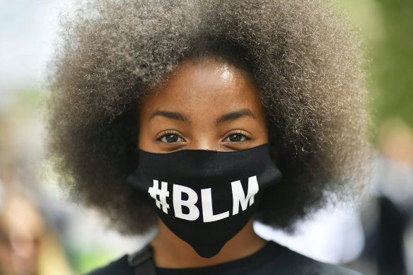 A protestor wearing a face mask to protect against coronavirus, takes part in a Black Lives Matter protest rally in the UK.