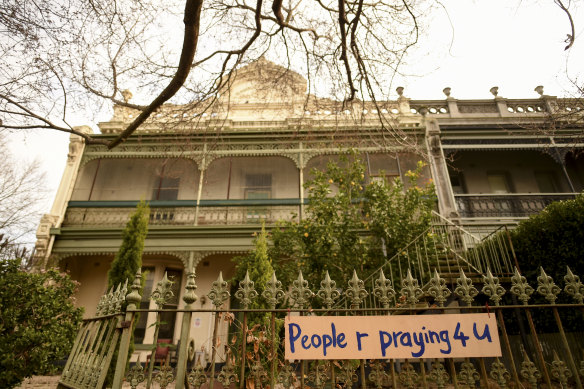 Messages of support: Signs on the fence at Hambleton House in Albert Park read "you are remembered" and "People r praying 4 u".