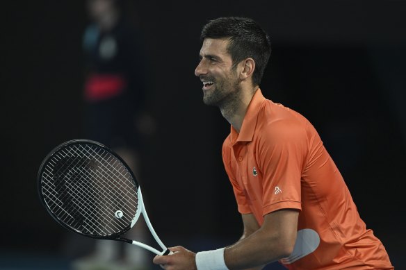 Novak Djokovic smiles as he faces Nick Kyrgios.