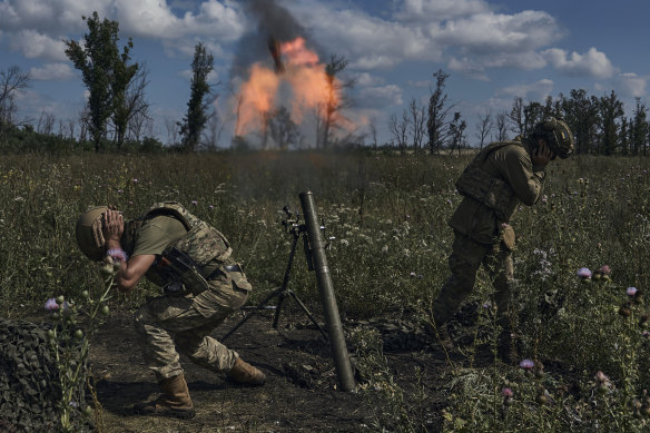 Ukrainian soldiers fire a mortar towards Russian positions at the front line, near Bakhmut, Donetsk region, Ukraine.