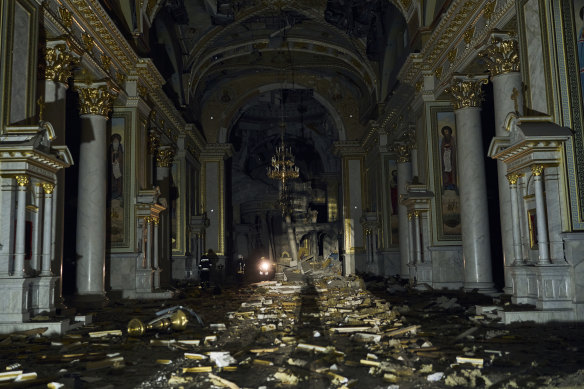 Firefighters walk inside the heavily damaged Odesa Transfiguration Cathedral.