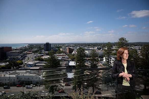 Frankston Mayor Sue Baker stands on top of an apartment building overlooking Port Phillip Bay. 