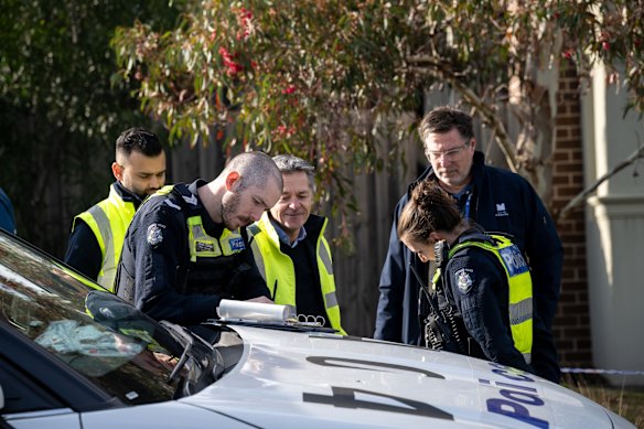 Detectives at the scene of the Chadstone house fire on Thursday.