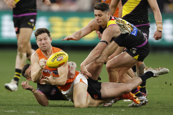 Toby Greene handballs.