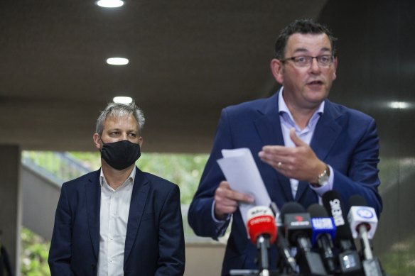 Premier Daniel Andrews addresses the media on Friday as Chief Health Officer Brett Sutton looks on.