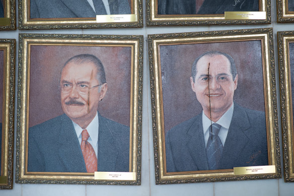 Damaged portraits of former Senate Presidents José Sarney and Renan Calheiros are seen at the Brazilian National Congress.