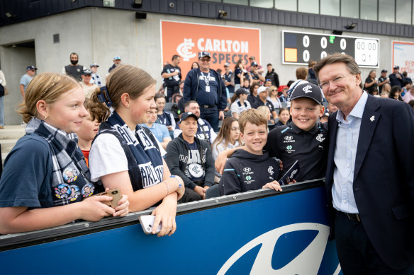 New Carlton president Robert Priestly poses with fans at a Blues training session.