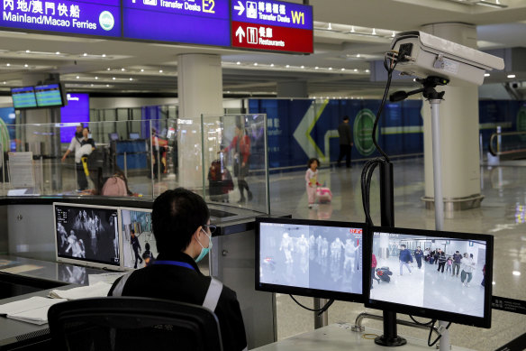 A health surveillance officer monitors passengers arriving at the Hong Kong International airport.