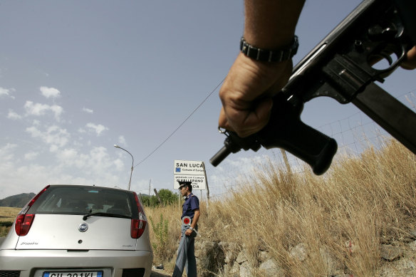 An Italian police officer at a roadblock near San Luca, a Calabrian town notorious as an organised crime stronghold.