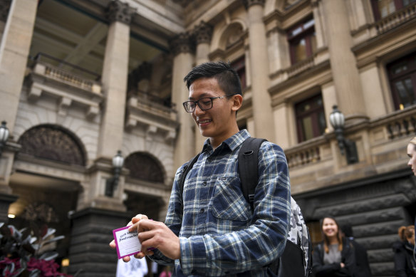 Nepalese international student Sajar Limbu at Melbourne Town Hall on Thursday with some of the vouchers.
