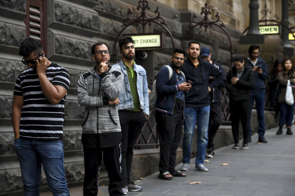 International students queuing outside Melbourne Town Hall on Thursday.
