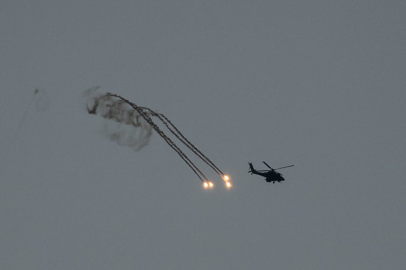 Israeli helicopter fires flares near the border with Gaza on December 29 in Southern Israel. 