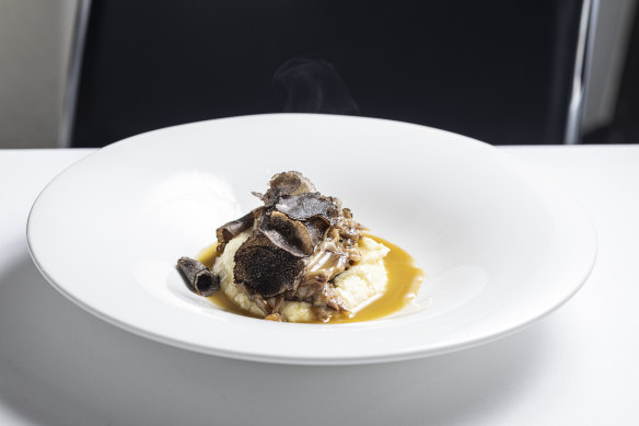 Veal shin served over white polenta with a shaving of truffles.