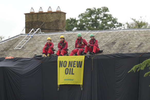 Greenpeace activists sit on the roof of Britain’s Prime Minister Rishi Sunak’s house in Richmond, North Yorkshire, England.