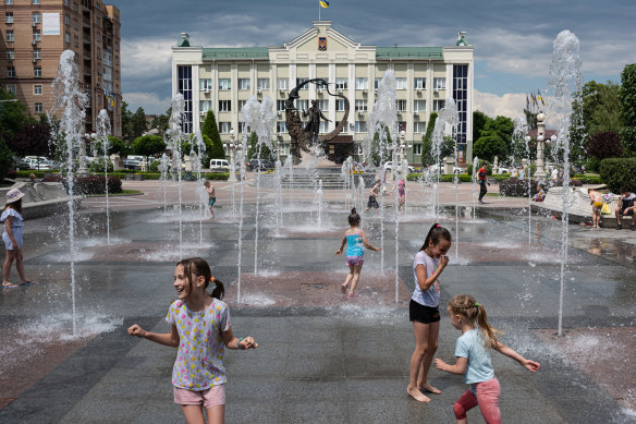 Children bathe in a reopened fountain on June 13, 2022 in Irpin, Ukraine.