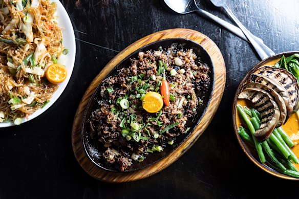 From left: Stir-fried rice noodles with vegetables, sisig kapampangan and kare-kare.