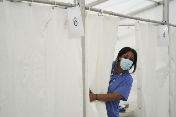 An NHS nurse looks for patients at a pop-up vaccination centre during a four-day COVID-19 vaccine festival in Langdon Park, east London, on Saturday July 31, 2021.  