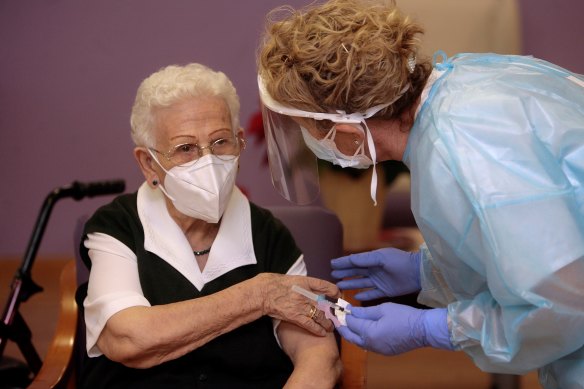 Araceli Hidalgo, 96, becomes the first person in Spain to receive a vaccine dose. She is pictured at the Los Olmos care home in Guadalajara, near Madrid, on Sunday.