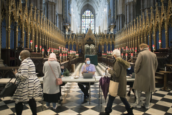 People arrive to receive their COVID-19 vaccine in Westminster Abbey, London. 