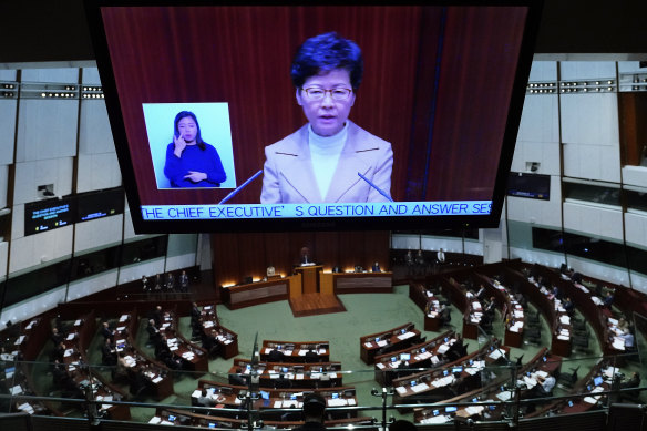 Carrie Lam's image looms over the parliament during a question and answer session.