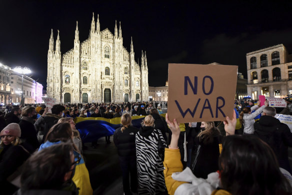 People gather to demonstrate in Duomo Square, Milan, Italy.