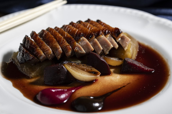 Duck marinated in koji fungus is served with smoked eggplant and black garlic puree.