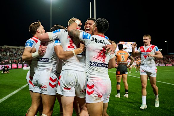 The Dragons celebrate a try against the Tigers on Saturday.