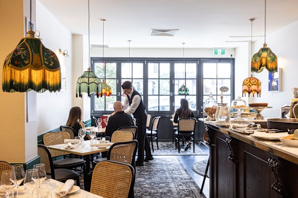 Fringed lampshades glow above each table in the downstairs dining room.