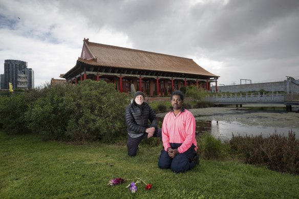 President of the Friends of Newells Paddock group Bruce Dickinson with Greg Rebelo, volunteer at the Heavenly Queen Temple with flowers left by members of the public for the dead swans.