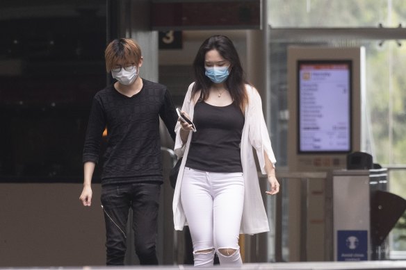 Commuters wear masks at St Leonards station on Monday.